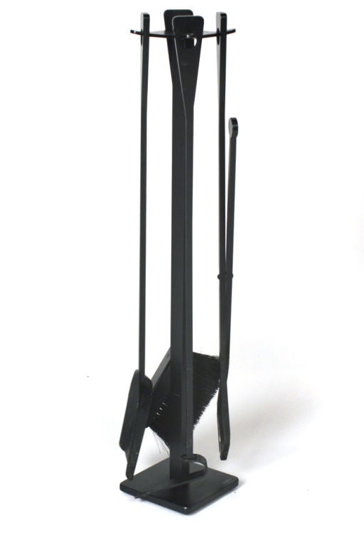 A modern set of fireplace accessories comprising four tools on stand and minimal clear glass and wrought iron fire screen.  Both with manufacturer's label 