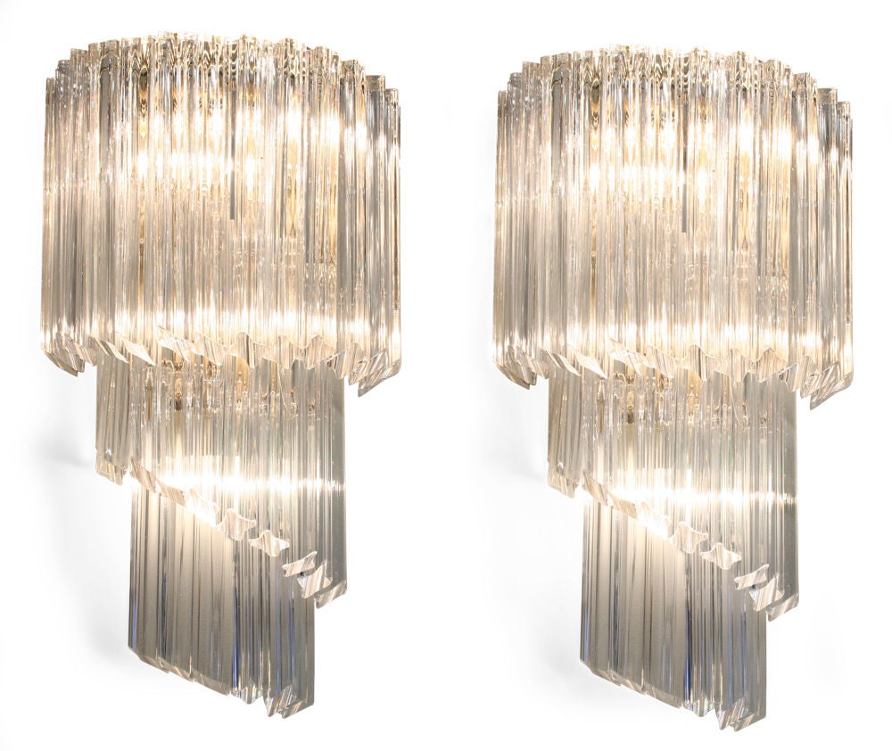 A shimmering pair of large sconces in a mirrored form of a twisting cascade of quatrefoil-shaped crystal glass rods by Camer Glass. Italy, circa 1960.
