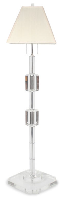 A translucent floor lamp comprised of tubular shafts separating two faceted gem-like blocks (Measures: 4