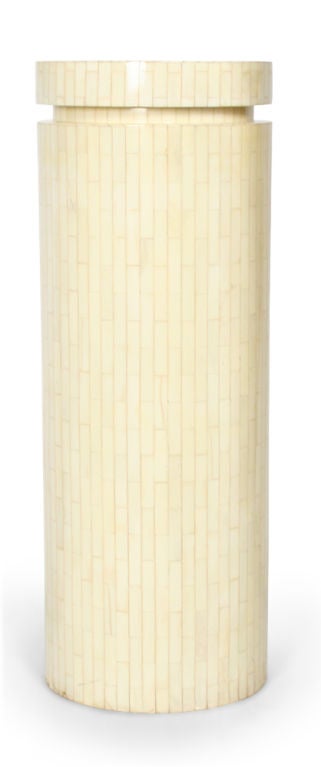 A tall display pedestal in a round column form all in bone veneer.  By Enrique Garces.  Colombian, circa 1970.