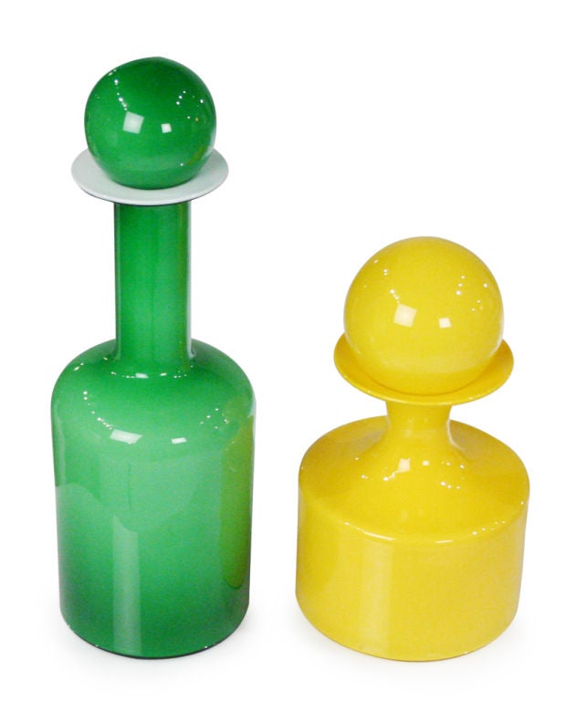 An wonderful pair of cased glass 'Gulvvase' vases with bottle-shape forms one in green with opal case glass the other in yellow with clear cased glass (this color-way was phased out in 1970), each with orb finials. By Otto Brauer and manufactured by