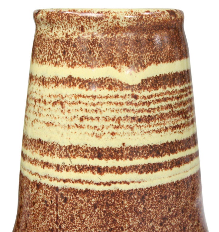 A beautiful vase with a wide, cylindrical neck and bulbous body; glazed in a speckled copper color with yellow ground. By Design Technics. U.S.A., circa 1950.
