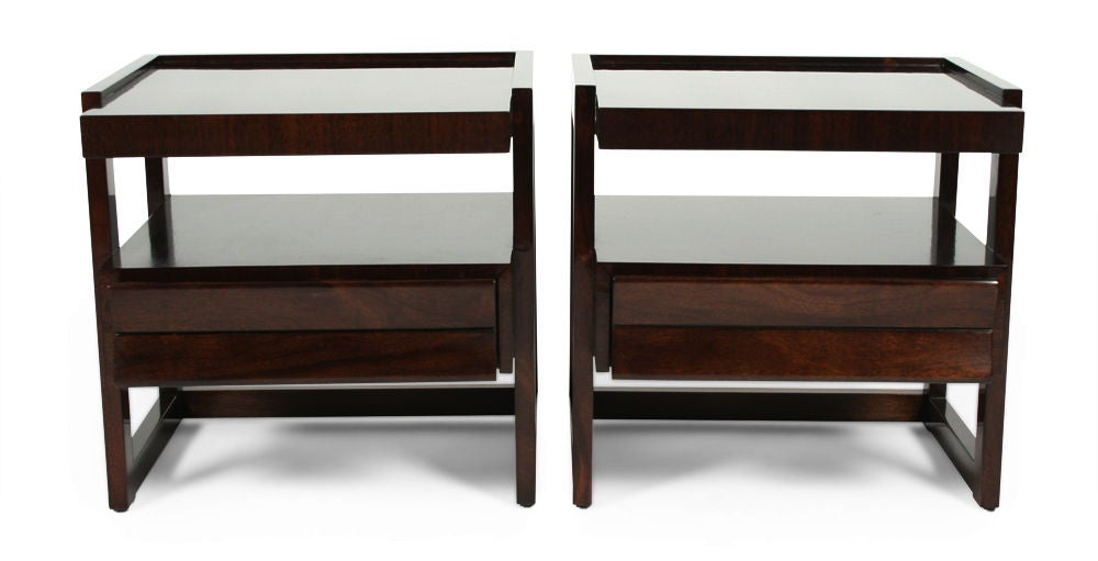 A pair of nightstands with a cantilevered top and 'glove box' drawer with paddle form pull. By Paul Laszlo for Brown Saltman. U.S.A., circa 1950.