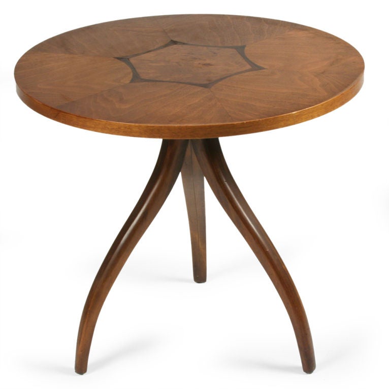 A dynamic occasional table comprising a circular top with a marquetry rosewood geometric hexagon design, resting on three swag legs. By Drexel. American, circa 1950. Pair available as well.