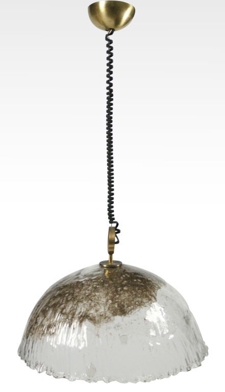 A large pendant having a dome form in handblown Murano glass in the 'Pulegoso' technique which is a randomly sized bubble effect seen here, also with a drapery edging to the bottom; also retains original brass fittings and canopy. Italy, circa