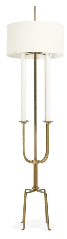 A wonderful floor lamp in gilt wrought iron with four arms and four legs.  By Tommi Parzinger. American, circa 1950.