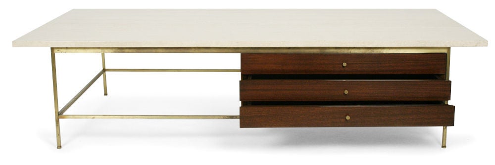 A generously scaled cocktail table with a clever marriage of wood, metal and Italian travertine stone with jewelry box style three-drawer storage cabinet, model. no. 8705, by Paul McCobb for Calvin. U.S.A., circa 1950.