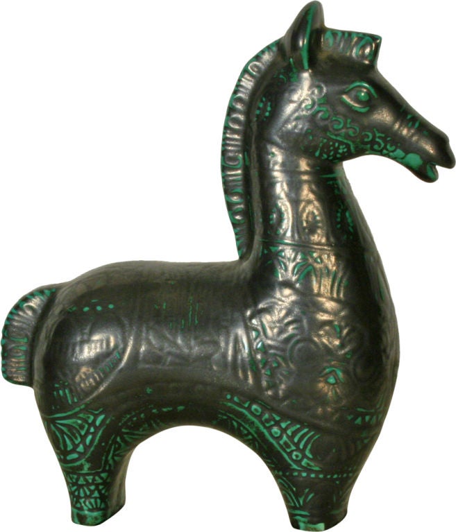 A wonderful sgraffito ceramic horse with incised design in black on an emerald ground with a gunmetal overglaze.  After Bitossi. English, circa 1950.
