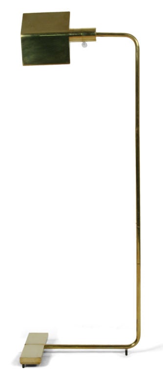A floor lamp comprising a swiveling pyramid shade with an acrylic ball dimmer switch that cantilevers on a rotating stem with a weighted base all in a polished brass finish. By Cedric Hartman, American, circa 1970.