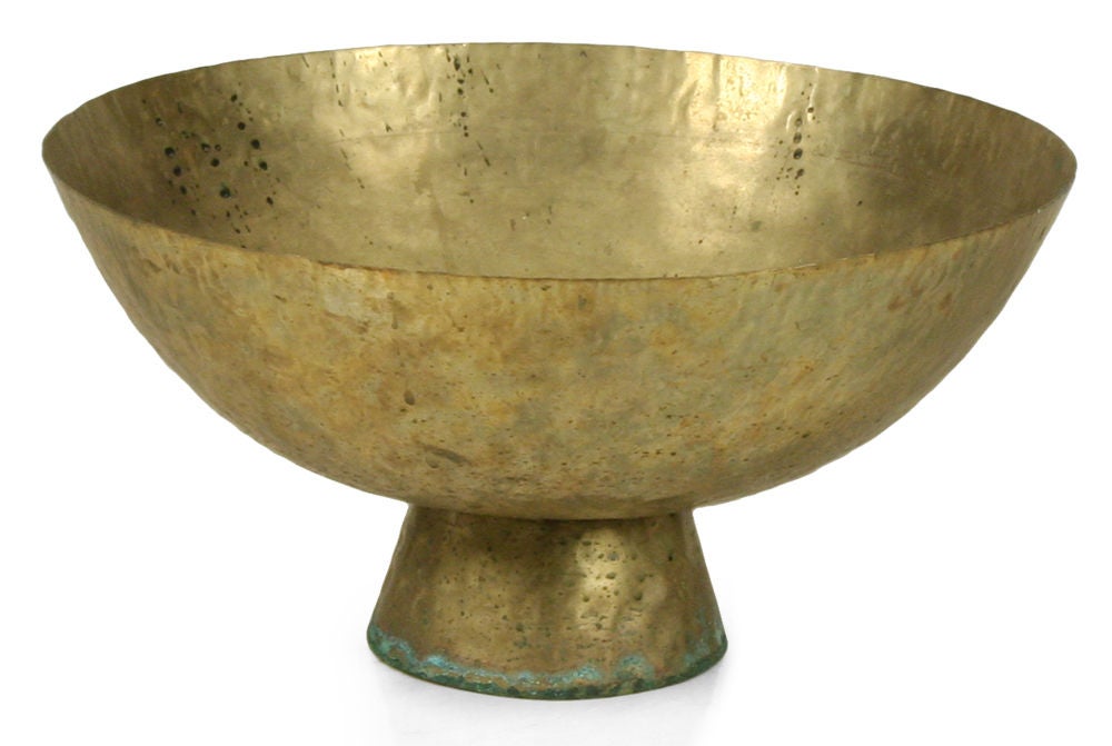 A wonderfully aged large brass bowl with a high flared foot; has an excellent patina and character.  Indian, circa 1960.