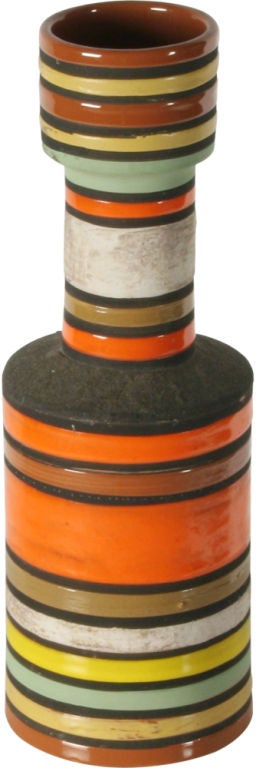 A wonderful vase in sand colored stoneware with circulating differently sized broad horizontal stripes in multicolor matte and high gloss glazes and a lava-like matte glaze. Manufactured by Bitossi for Raymor. Marked: 1390 B, ITALY (black glaze,