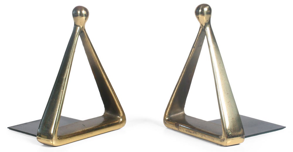 A cool pair of bronze bookends in triangle forms with tear drop form finials. Stamped Jenfred Ware and with paper Raymor label. Designed by Ben Seibel for Jenfred Ware, American, circa 1960s.