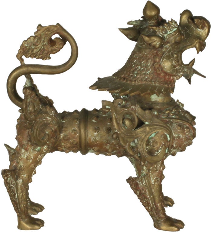 A bestial bronze sculpture in the form of a standing fu dog with elaborate ornate details. Chinese, circa 1960.