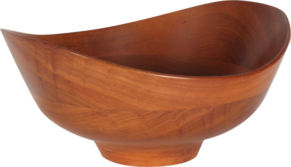 A sculptural fruit bowl made from lathe turned teak with an undulating rim and flared body all resting on a circular foot. Designed by Finn Juhl, made by Magne Monsen for Kay Bojesen. Denmark, circa 1950.