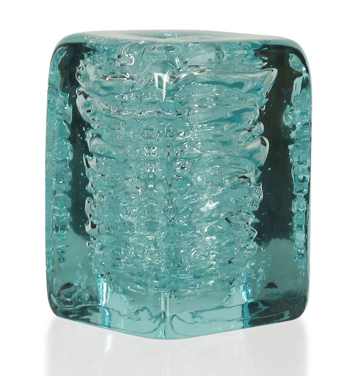 A unique bud vase in a stout rectangular molded form with an interior detail of thick Pulegoso like detail giving it an icy bubble effect.  Czech, circa 1960.
