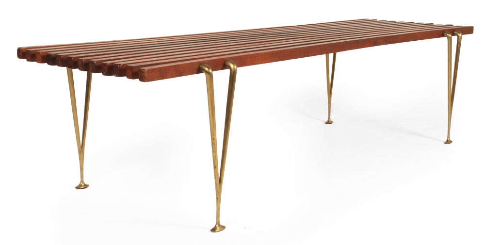An iconic Mid-Century bench comprising 'suspended' walnut beams supported by sculptural bronze cast legs without screws or glue.  Designed and manufactured by Hugh Acton.  American, circa 1950.