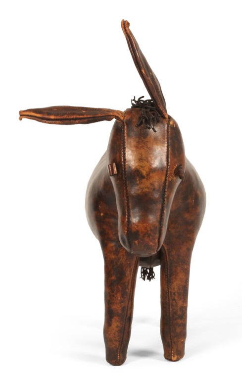 A hand-made stuffed donkey with wire and wood frame, wool stuffing and stained leather with a waxed finish. The original donkey designed by Dimitri Omersa won a gold medal at The California State Fair in 1963. With label 
