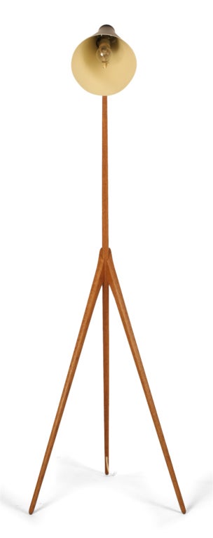 A graceful reading lamp with a black enameled metal conical shade supported by a teak tripod stand. By Luxus. Swedish, 1960.<br />
55.75