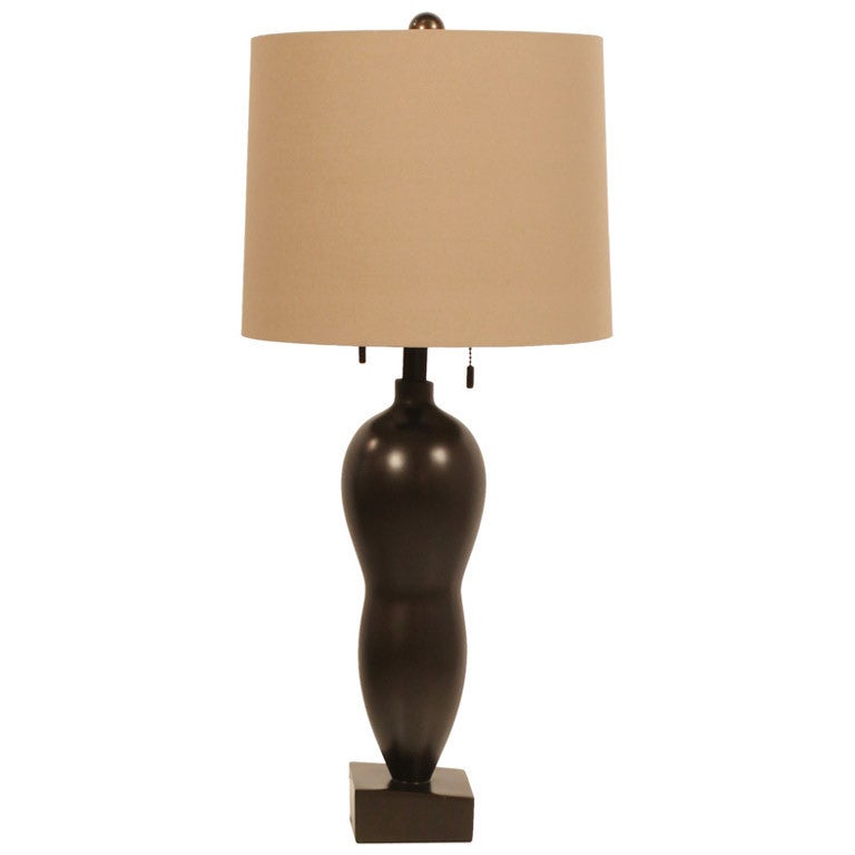 A sensual pair of table lamps comprising a bronze finished voluptuous resin body raised on asymmetrical block bases.  Mod. no. 800001-05. By John Hutton for Donghia.  American, 1992.