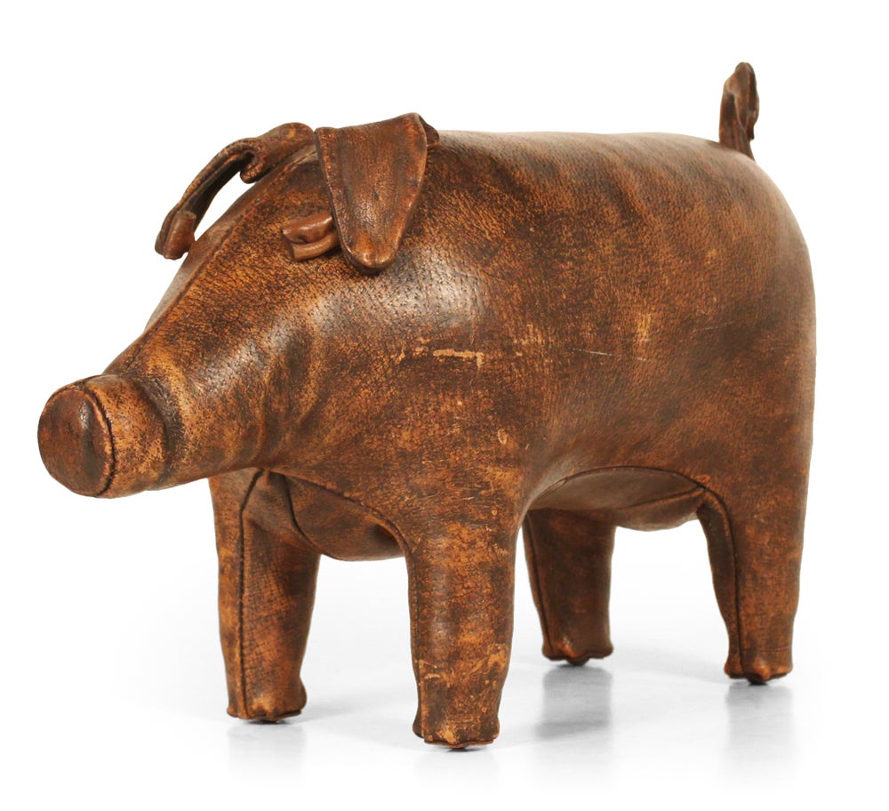 A delightful ottoman or doorstop in hand-stitched aged leather in the form of a small pig. By Dimitri Omersa. English, circa 1950.