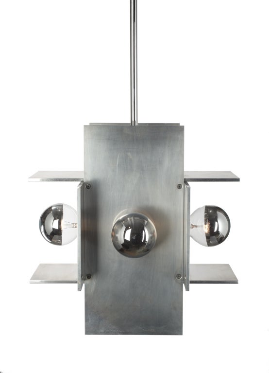 A large pendant light comprising thick aluminum plates in perpendicular and parallel planes forming a perfect cube, each section holds a single bulb. Designed by Paul Mayen for Habitat. U.S.A., circa 1960.