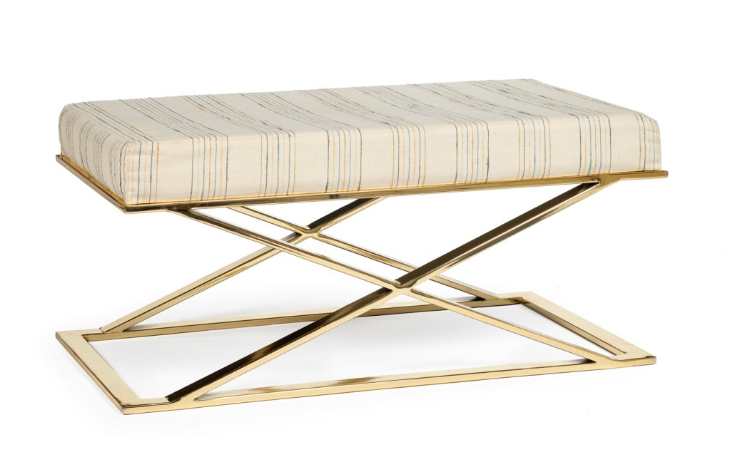 A lustrous bench comprising an upholstered seat resting on a polished brass plate X-frame base. With label to base.  By Milo Baughman for Thayer Coggin.  American, circa 1970.
Price is COM.