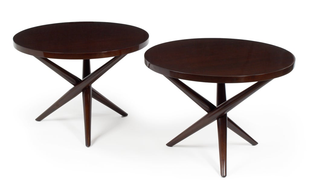 A pair of lamp tables with round tops supported by a criss-cross tripod base. Model no. 1641. By T.H. Robsjohn-Gibbings for Widdicomb Furniture Company. U.S.A., circa 1950. Price COF.