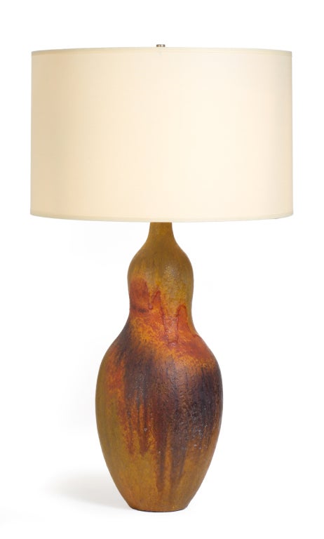 An earthy ceramic table lamp in a bulbous gourd form with a drip glaze in earth tones of rust, maroon, orange, and ochre. Signed to the base. By Marcello Fantoni for Raymor. Italy, circa 1950.