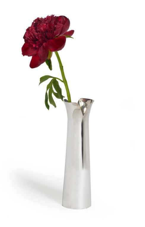 A sensuously sleek vase in silver plate with a flared, split neck and round columnar form. Marked 