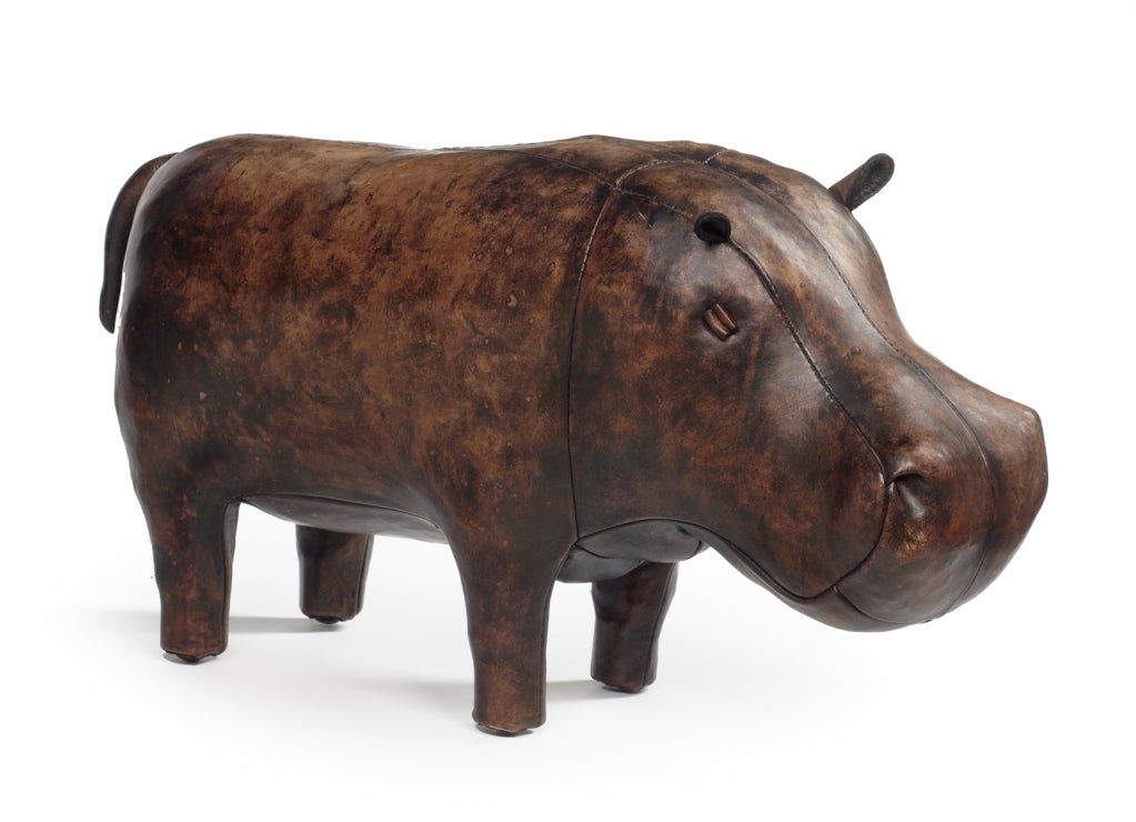 A hand-made stuffed hippo footrest comprising a wire and wood frame, wool stuffing and stained leather with a waxed finish. By Omersa. English, circa 1960.