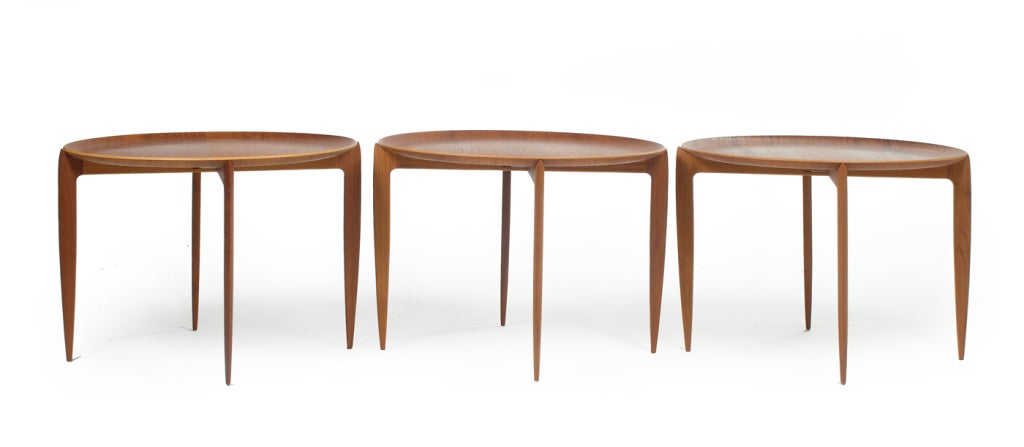 A set of tray tables with a removable molded teak plywood circular tray top on folding pinwheel base, each in original finish and original boxes. 
Model no. 4508. With Fritz Hansen decals and stamps. Designed by H. Engholm for Fritz Hansen. Danish,