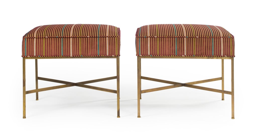 A pair of benches with square seats supported by a slim brass frame with square legs and X-stretcher. Model no. 1306. By Paul McCobb for Directional. American, circa 1950. Price is Customer's Own Material, but includes labor to reupholster.