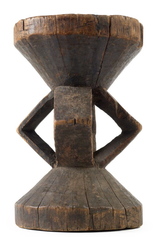 A Southern African, Tonga stool comprising a circular cone form seat with carved triangle shape support all on a circular cone form base. Chigaro is what the Tonga people termed these seats as and they were important status symbols used by the head