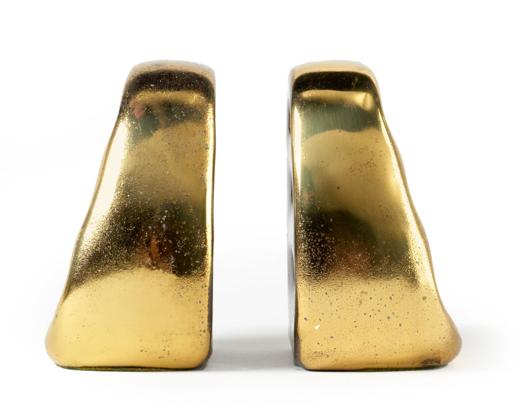 A set of four bookends in brass plated metal. By Ben Seibel for Jenfred-Ware and Distributed by Raymor. U.S.A., circa 1950.