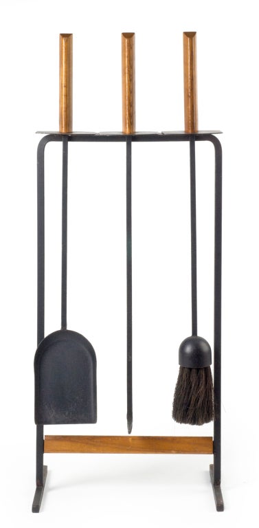A free standing set of three fireplace tools in wrought iron and walnut. After Tony Paul. American, circa 1950.