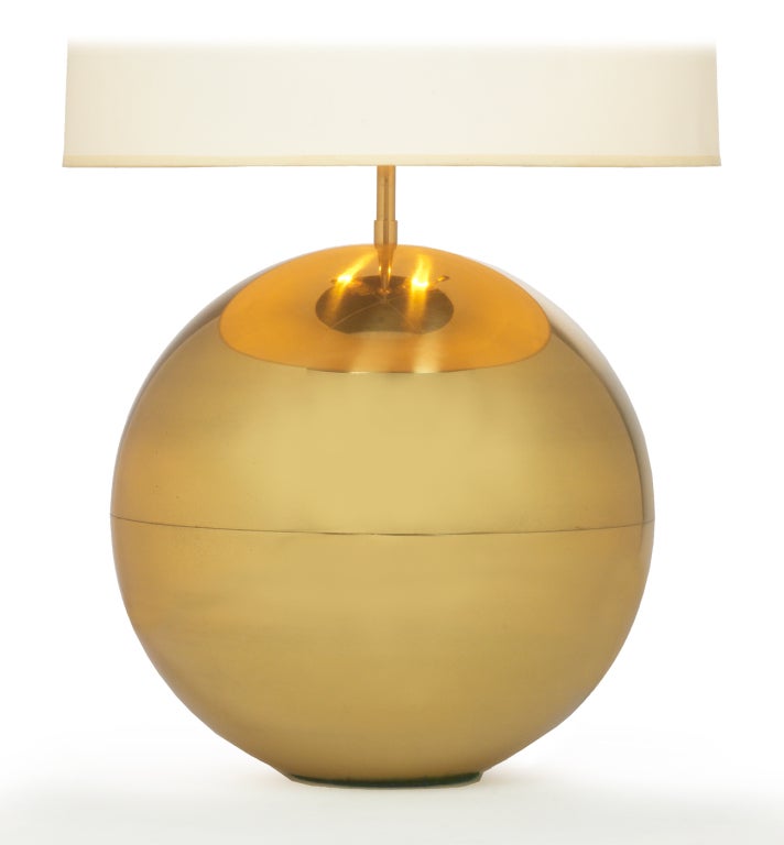 A chic table lamp in a perfect sphere made in polished brass.  By Karl Springer. American, circa 1970.