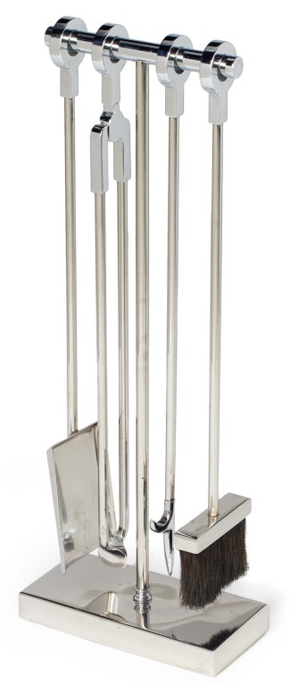 A bold set of Minimalist fireplace tools in nickel-plated steel comprising four implements each with a circular 'ring' handle that slides over and registers securely into a notch on the integral floor stand. By Danny Allessandro. U.S.A., circa