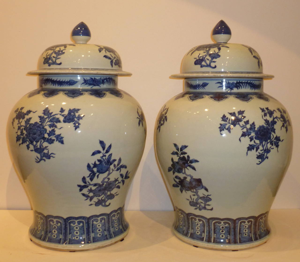 A pair of refined and elegant porcelain jars with covers,  hand-painted blue and white floral motif. Beautiful color, form and lines. 12