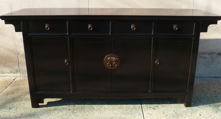 simple and refined black lacquer sideboard, four drawers on top of two pairs of doors, brass ring pulls, 19th century