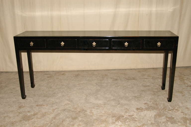 A fine black lacquer table with five drawers, framed top supported by straight legs and joined by five drawers with brass ring pulls. View our website at: www.greenwichorientalantiques.com for additional table with drawers selection.
