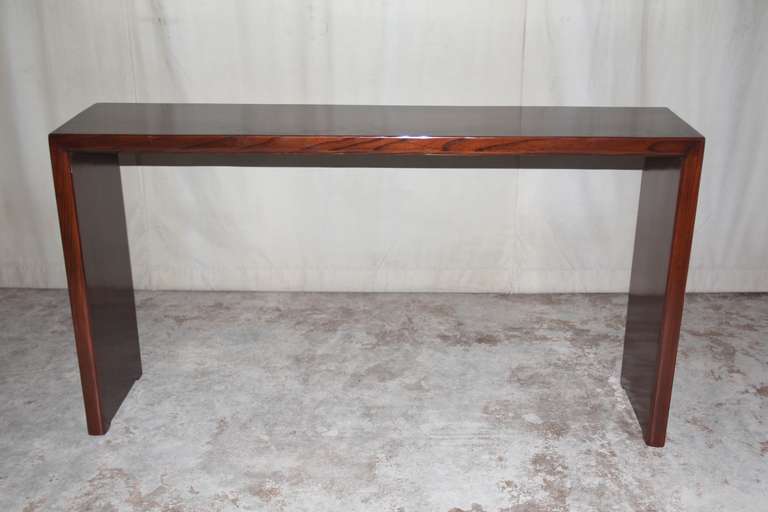 A simple and elegant console table, single plank top supported by paneled legs, beautiful color, form and lines.