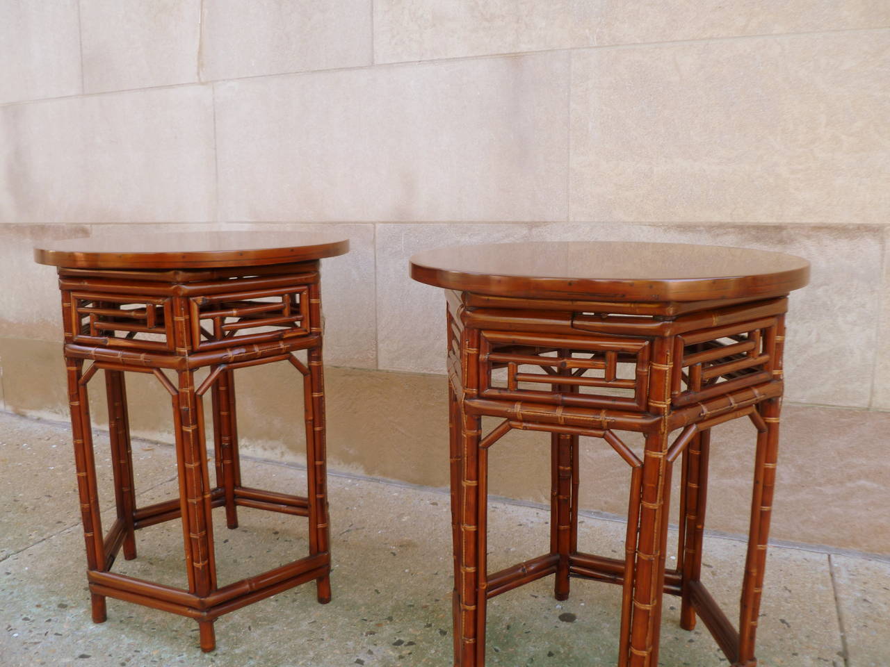 A Pair Of Round Bamboo End Tables With Black Lacquer Tops 1