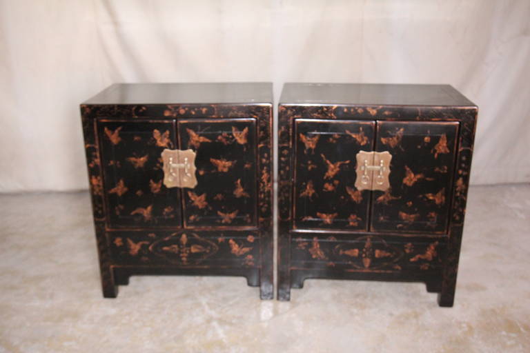A pair of very elegant chests, of upright form, black lacquer with muted gold gilt flowers and butterflies motif on the front side, brass fitting.