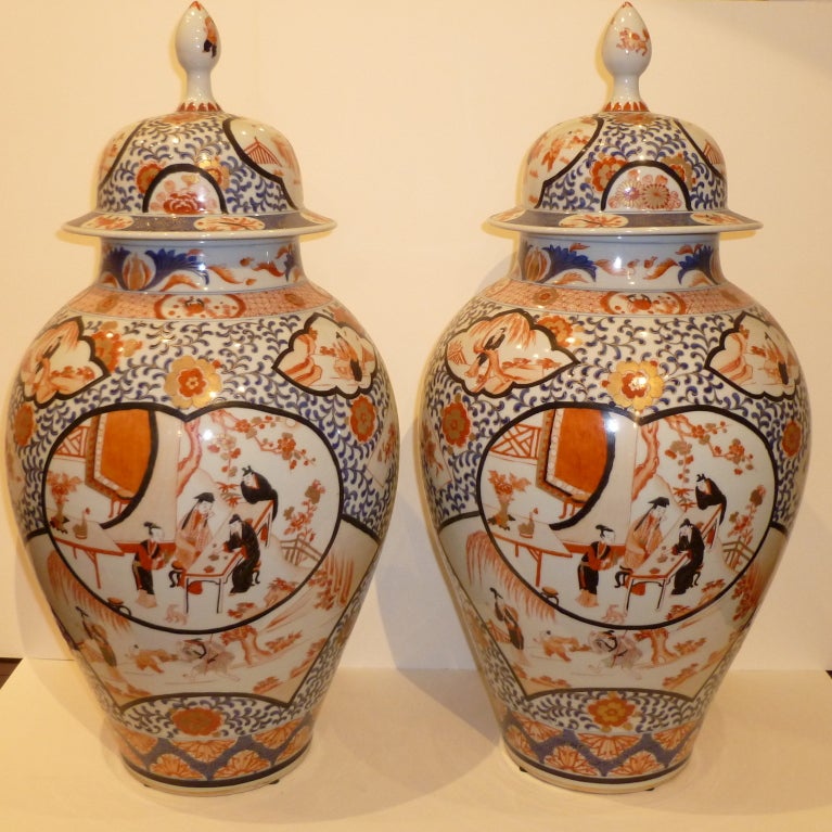 A pair of fine Chinese imari porcelain jars with covers, elegant hand painted polychrome and gold gilt motif. Beautiful colors, form and lines.
