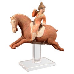 A Superb and Playful Tang Dynasty Pottery Statue of Lady Polo Player