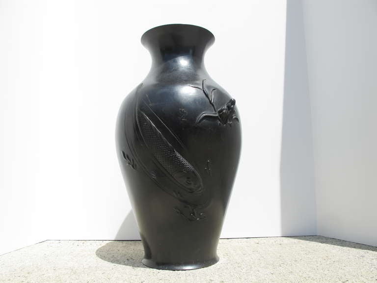 Large Japanese vase with two raised  koi one leaping and the other diving creating a stylized wave.
