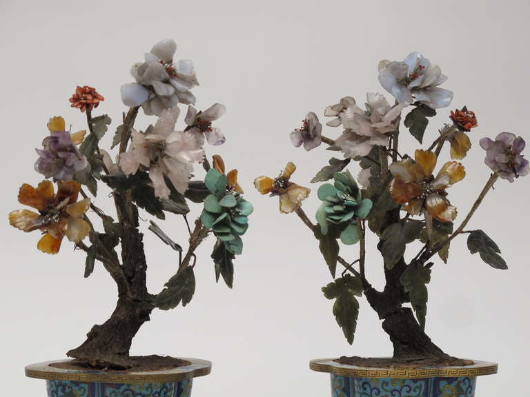 Pair of bonsai trees with glass and cut stone leaves and flowers in cloisonné pots. 