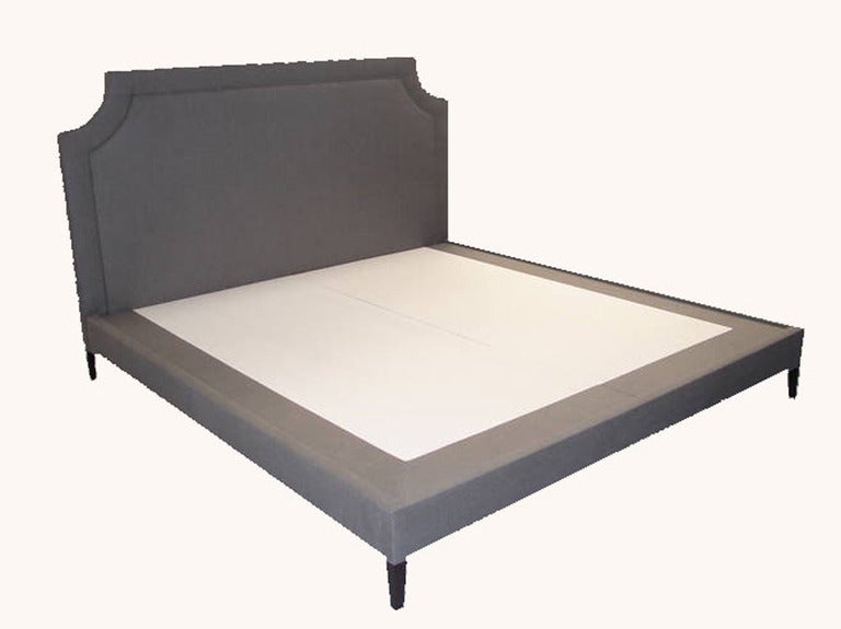 King-size upholstered platform bed on solid tapered walnut legs.

Custom orders have a lead time of 10-12 weeks FOB NYC. Lead time contingent upon selection of finishes, approval of shop drawings (if applicable) and receipt COM (if applicable).