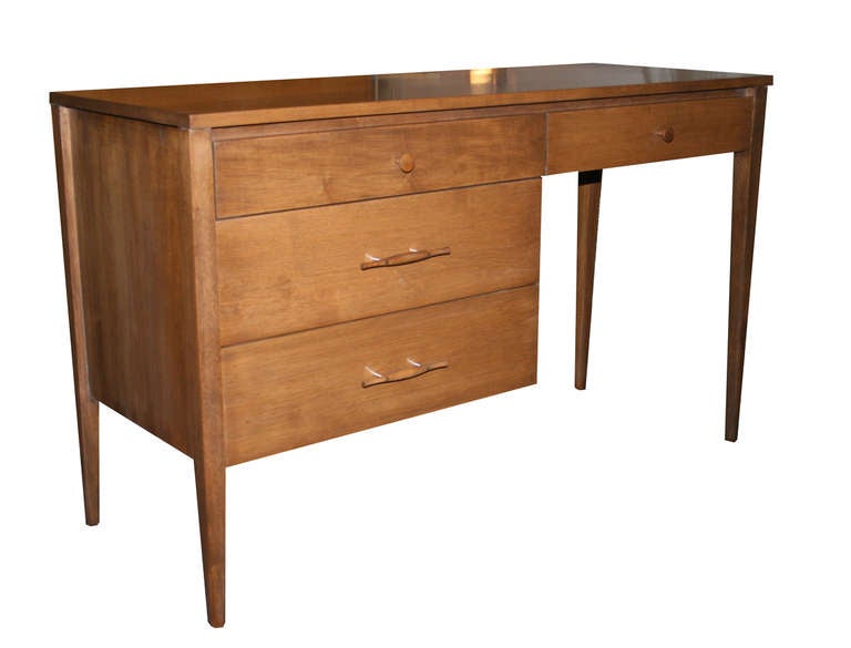 Paul McCobb solid maple 4 drawer Planner group writing desk Ca. 1950's in finely restored condition.Solid maple construction walnut finish with original  solid wood turned hardware.

Paul McCobb (1917-1969) is an American designer best known for