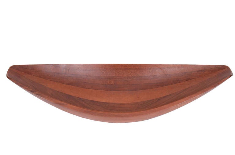 Early Dansk Denmark staved teak bowl, designed by Jens Quistgaard in the late 50s with 4 floating ducks mark. Marked: "DANSK DESIGNS", "DANMARK", "IHQ", and "STAVED TEAK". Measures about 24 1/4" long x 11